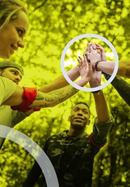 People celebrating teamwork with hands together in outdoor group activity